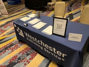Table with dark blue tablecloth and WPS logo